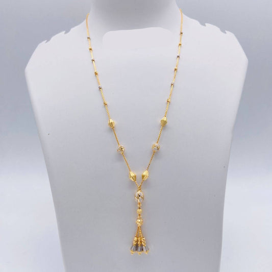 Gold necklace with tassel pendant on a mannequin bust, weight 7.770g, brand 'Sj221'.