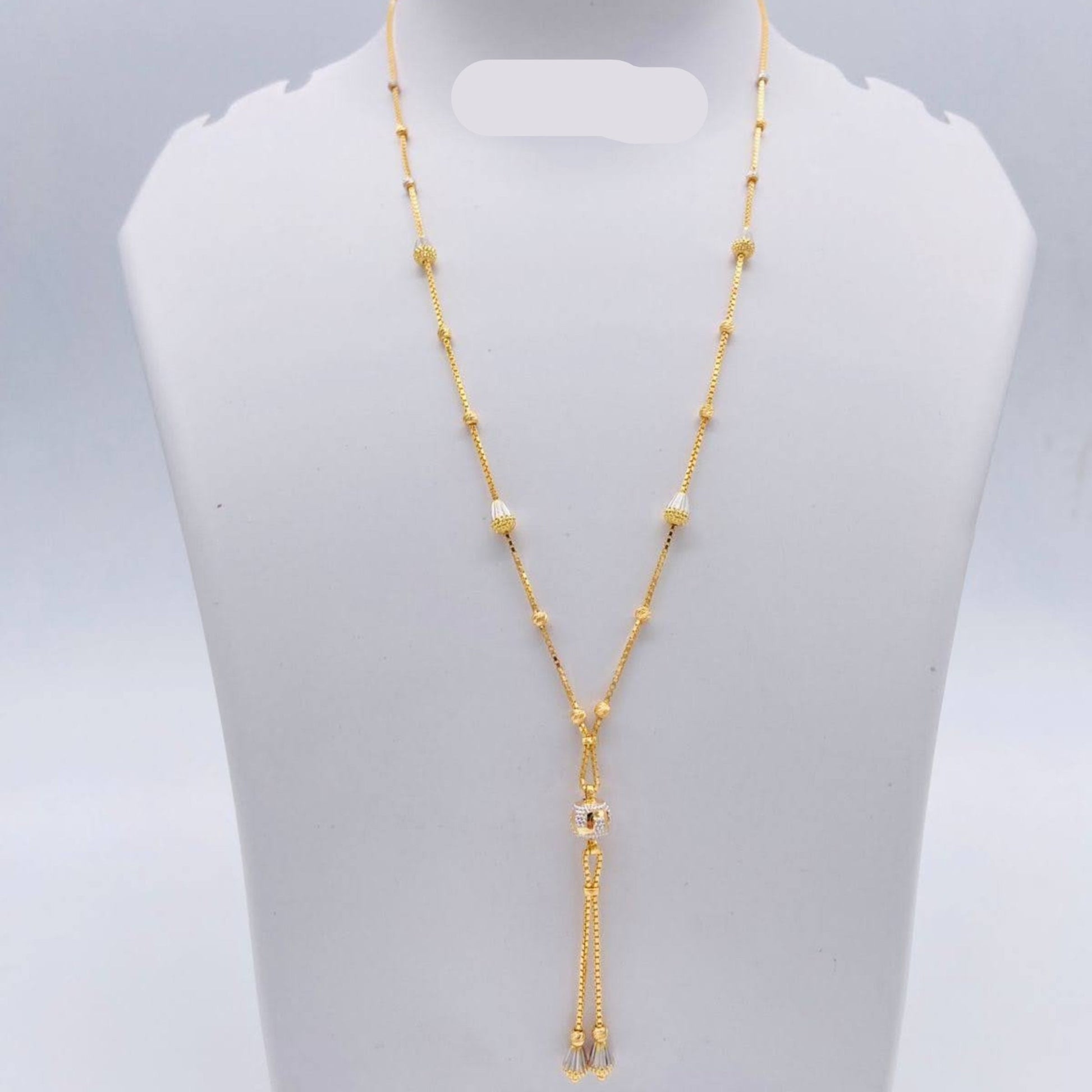 Gold necklace on a gray mannequin bust with weight indication