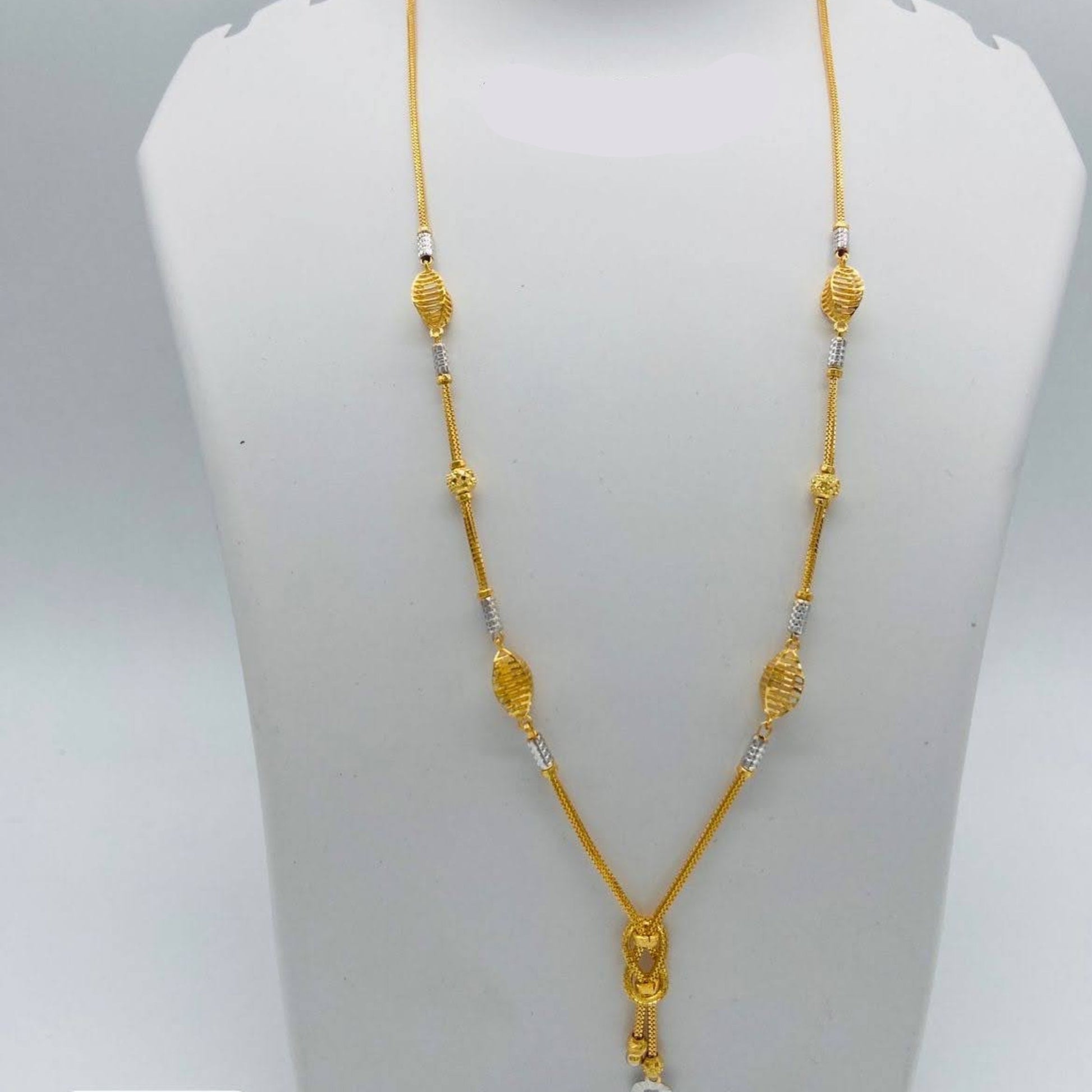 Gold necklace on a mannequin bust with weight and length information.