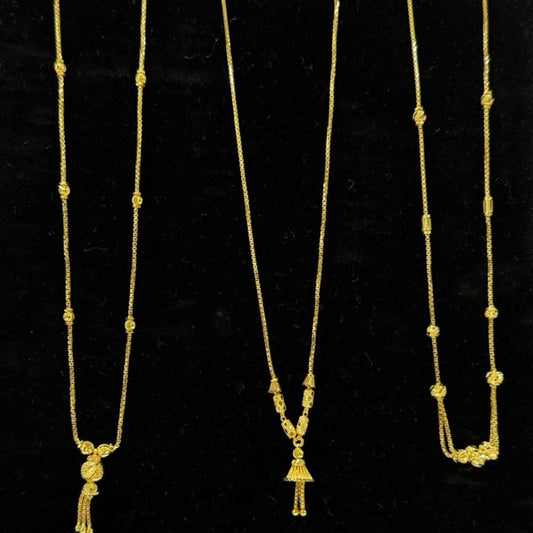 Three gold necklaces on a black display stand