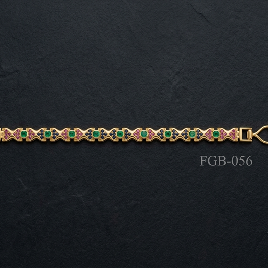 A gold-plated bracelet featuring a repeating pattern of green round-cut stones and pink enamel details, displayed horizontally on a dark textured slate background.