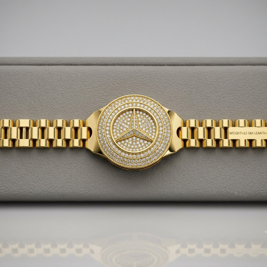 A gold-tone Mercedes-Benz watch with a diamond-encrusted bezel and matching diamond-embellished bracelet, displayed on a gray textured watch box.