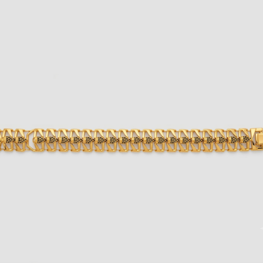 A gold-toned metal link bracelet with a repeating geometric pattern, displayed horizontally against a light gray background.