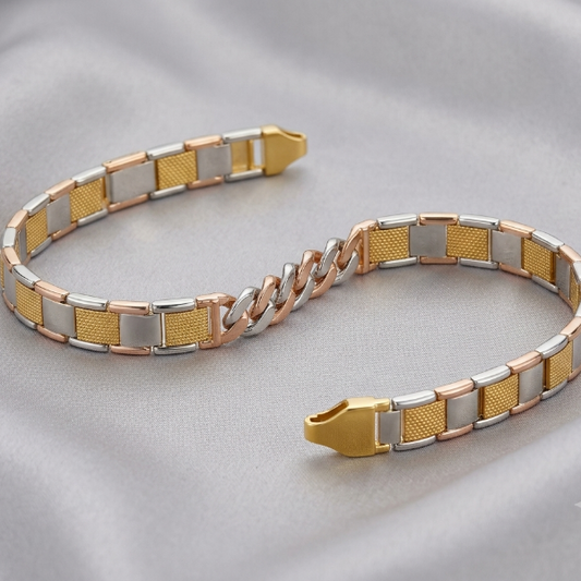 A two-tone metal bracelet with alternating gold, silver, and rose gold textured and smooth rectangular links, displayed on a soft gray satin fabric background.