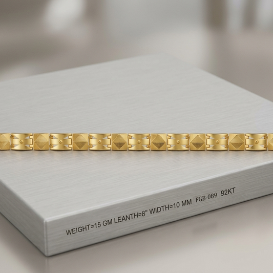 A gold link bracelet with faceted geometric links, displayed horizontally on a brushed silver presentation box. The box features printed specifications: 'WEIGHT=15 GM LEANTH=8" WIDTH=10 MM | Pb-089 92KT'.