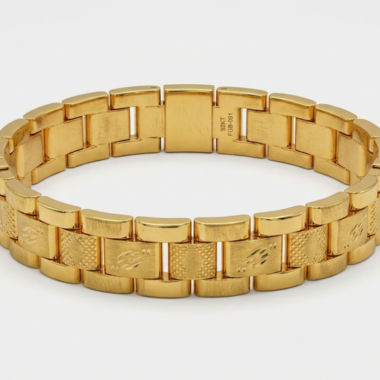A gold-tone metal link bracelet with a polished and textured link design, displayed on a clean white background.