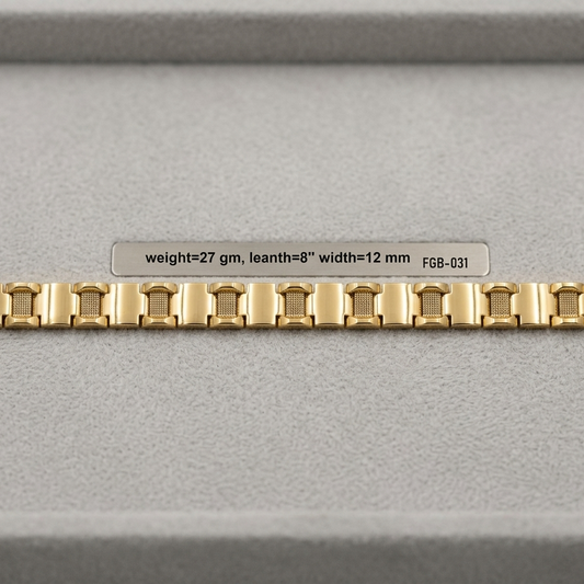A gold-colored metal watch band with a repeating rectangular link pattern, displayed horizontally on a gray textured surface with a small label above it.