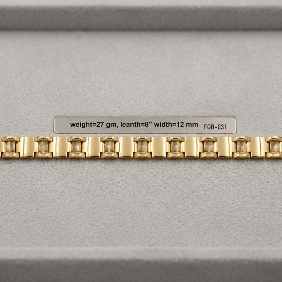 A gold-colored metal watch band with a repeating rectangular link pattern, displayed horizontally on a gray textured surface with a small label above it.