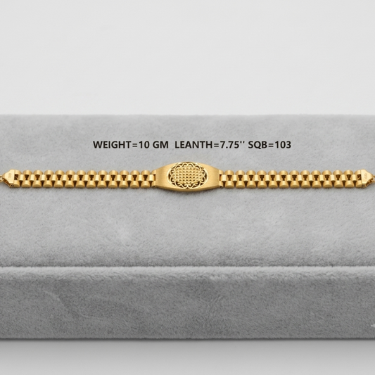 A gold bracelet displayed on a gray velvet jewelry box. The bracelet features a central textured oval clasp and a beaded link design.