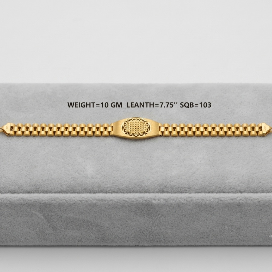 A gold bracelet displayed on a gray velvet jewelry box. The bracelet features a central textured oval clasp and a beaded link design.