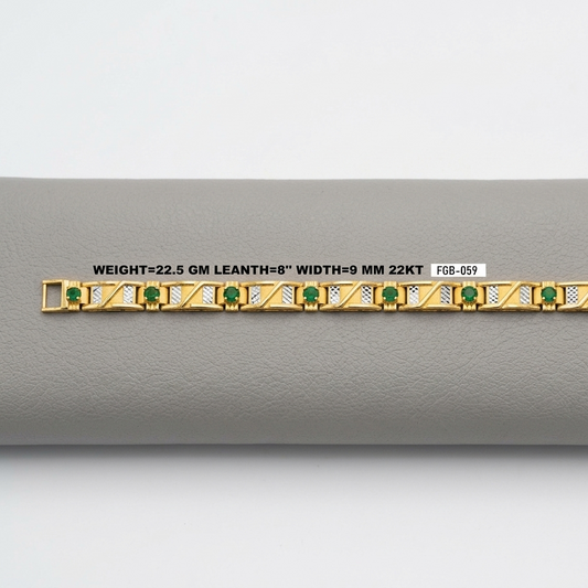 A gold bracelet with green emerald-cut stones and gold geometric detailing, displayed horizontally on a gray textured surface with a white label showing specifications.