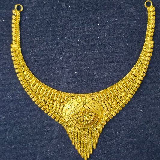A gold-toned traditional necklace with intricate filigree patterns and a central medallion, displayed on a dark textured background.