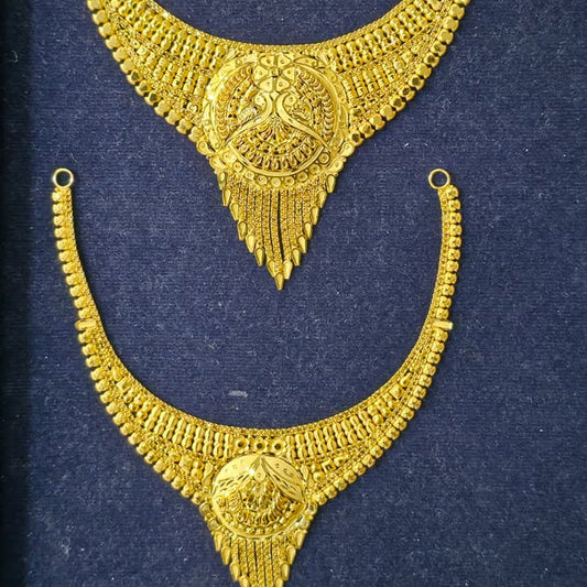 A pair of ornate gold-toned traditional necklace pieces displayed on a dark navy velvet jewelry box insert.