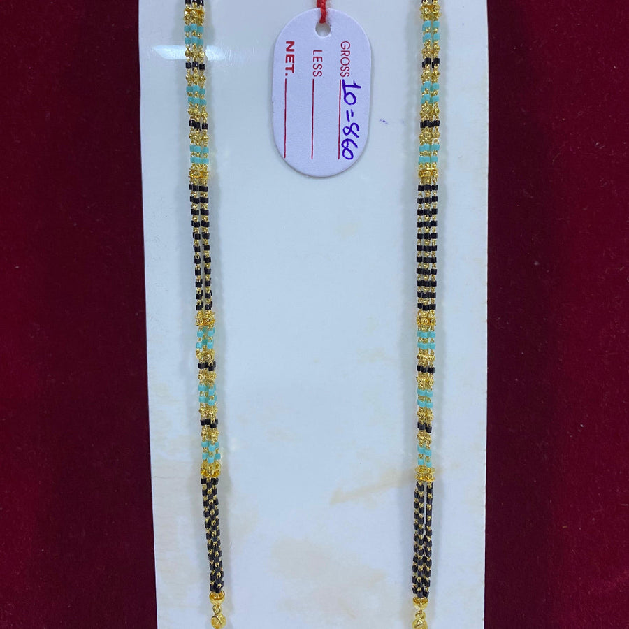 Two beaded necklaces on a white stand with a red background