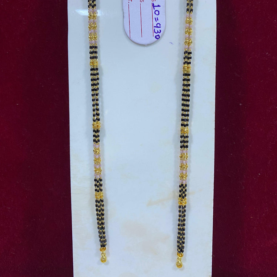 Two black and gold beaded bracelets on a white card with a visible brand tag.