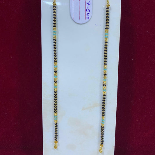 Two beaded necklaces on a white card with a visible tag, against a red background.