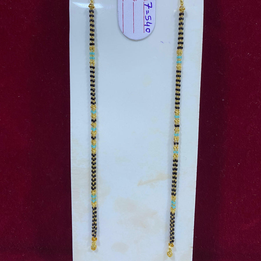 Two beaded necklaces on a white card with a visible tag, against a red background.
