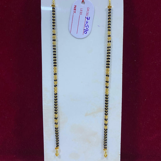 Two gold necklaces on a white card with a red background