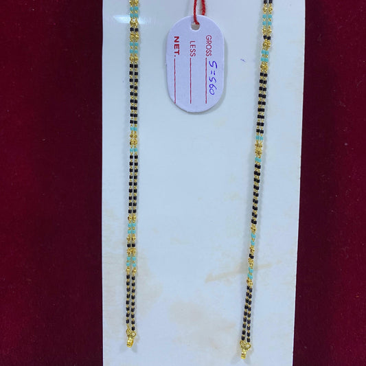 Two gold necklaces on a white card with a red background