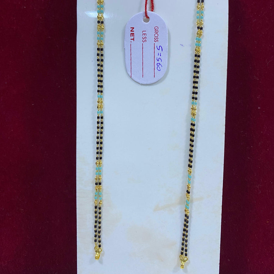 Two gold necklaces on a white card with a red background