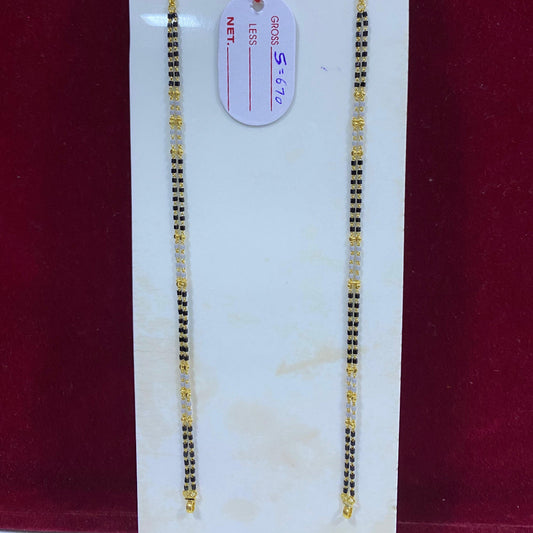 Two gold necklaces on a white card with a red background