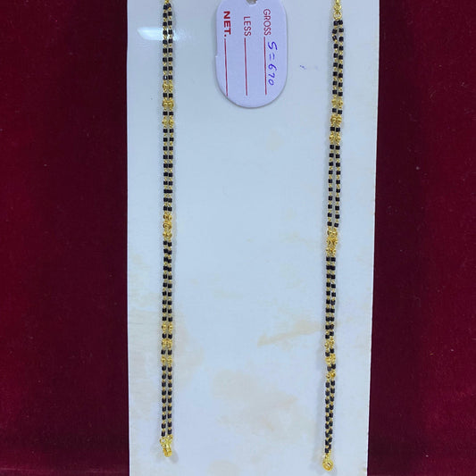 Two gold necklaces on a white card with a red background