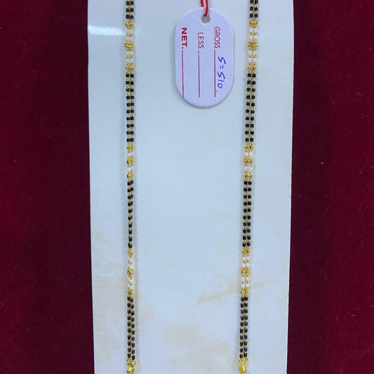 Two gold necklaces on a white card with a red background