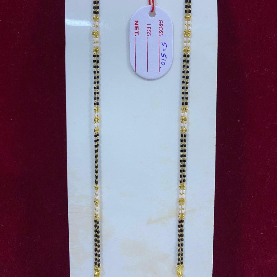 Two gold necklaces on a white card with a red background