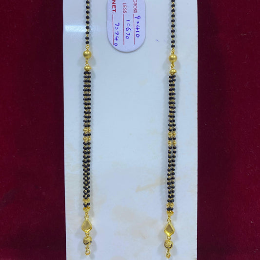 Two gold and black beaded necklaces on a white card with a red background