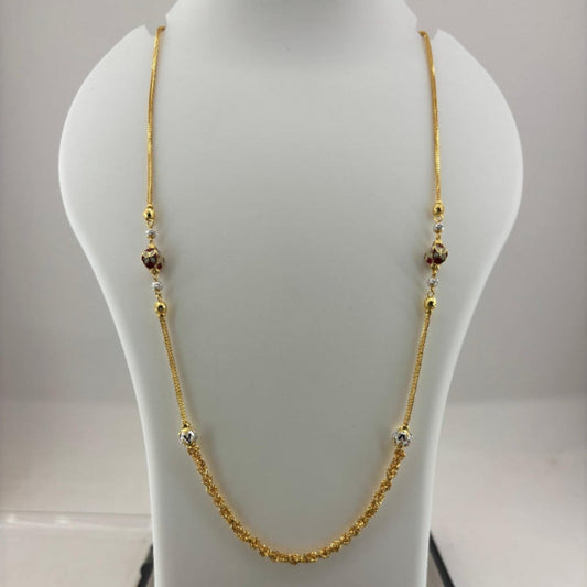 A gold chain necklace with small decorative beads displayed on a white jewelry bust, with a digital scale visible underneath.