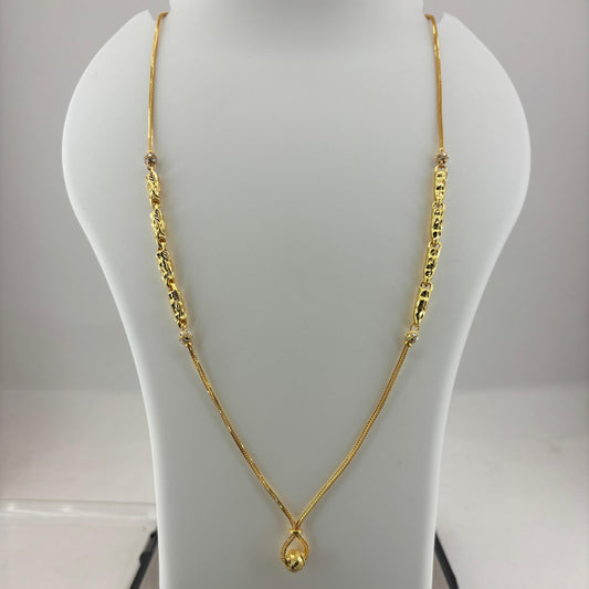 A gold necklace with a teardrop pendant displayed on a white mannequin bust, with a digital scale underneath showing a weight of 8.14 grams.