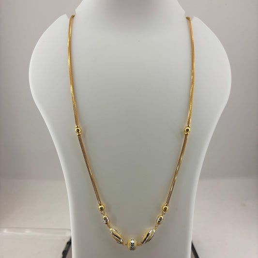 A gold chain necklace with small bead details and a central decorative pendant, displayed on a white jewelry bust over a digital scale showing 11.8 grams.