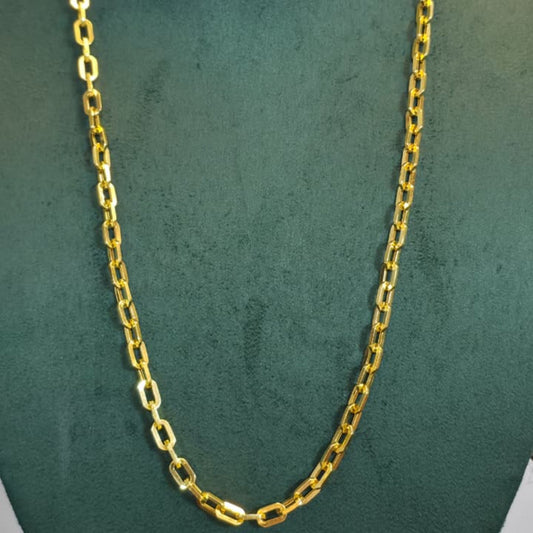 A gold chain necklace displayed on a dark green velvet jewelry bust against a light gray background.