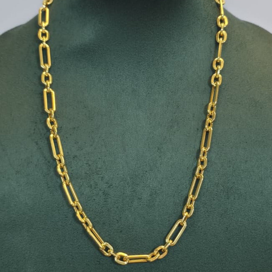 A gold chain necklace with elongated oval links displayed on a dark green jewelry bust against a light gray background.