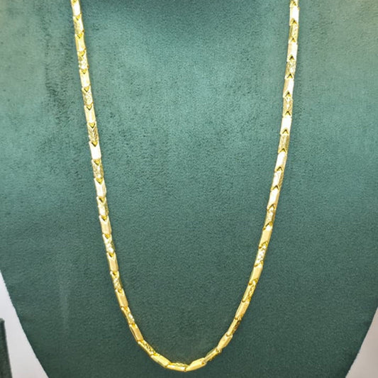 A gold chain necklace displayed on a dark green velvet jewelry bust against a plain light background.