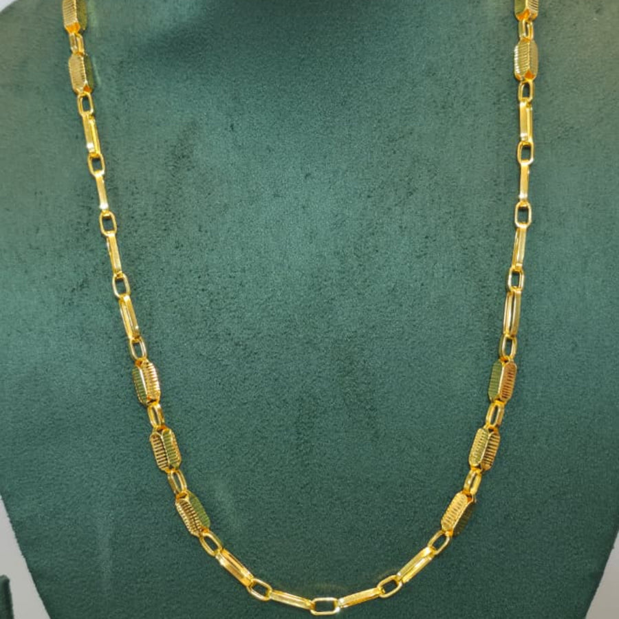 A gold chain necklace with rectangular links displayed on a dark green jewelry bust against a light gray background.