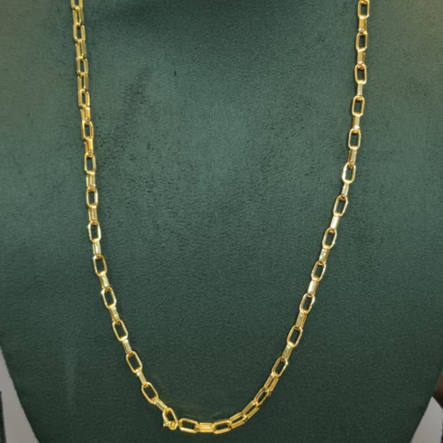 A gold chain necklace displayed on a dark green jewelry bust against a light gray background.