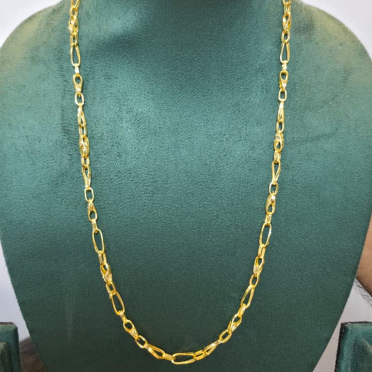 A gold Figaro chain necklace displayed on a dark green velvet jewelry bust against a plain white background.