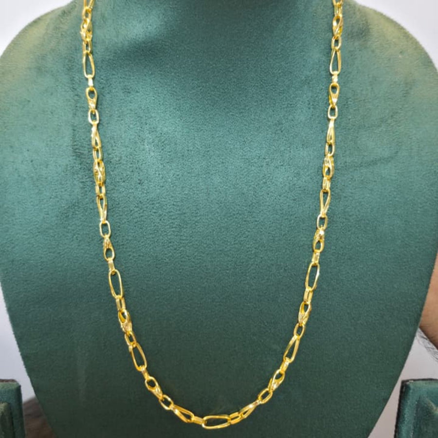 A gold Figaro chain necklace displayed on a dark green velvet jewelry bust against a plain white background.