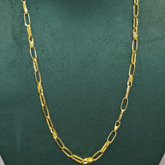 A gold chain necklace with elongated oval links, displayed on a dark green velvet jewelry bust.