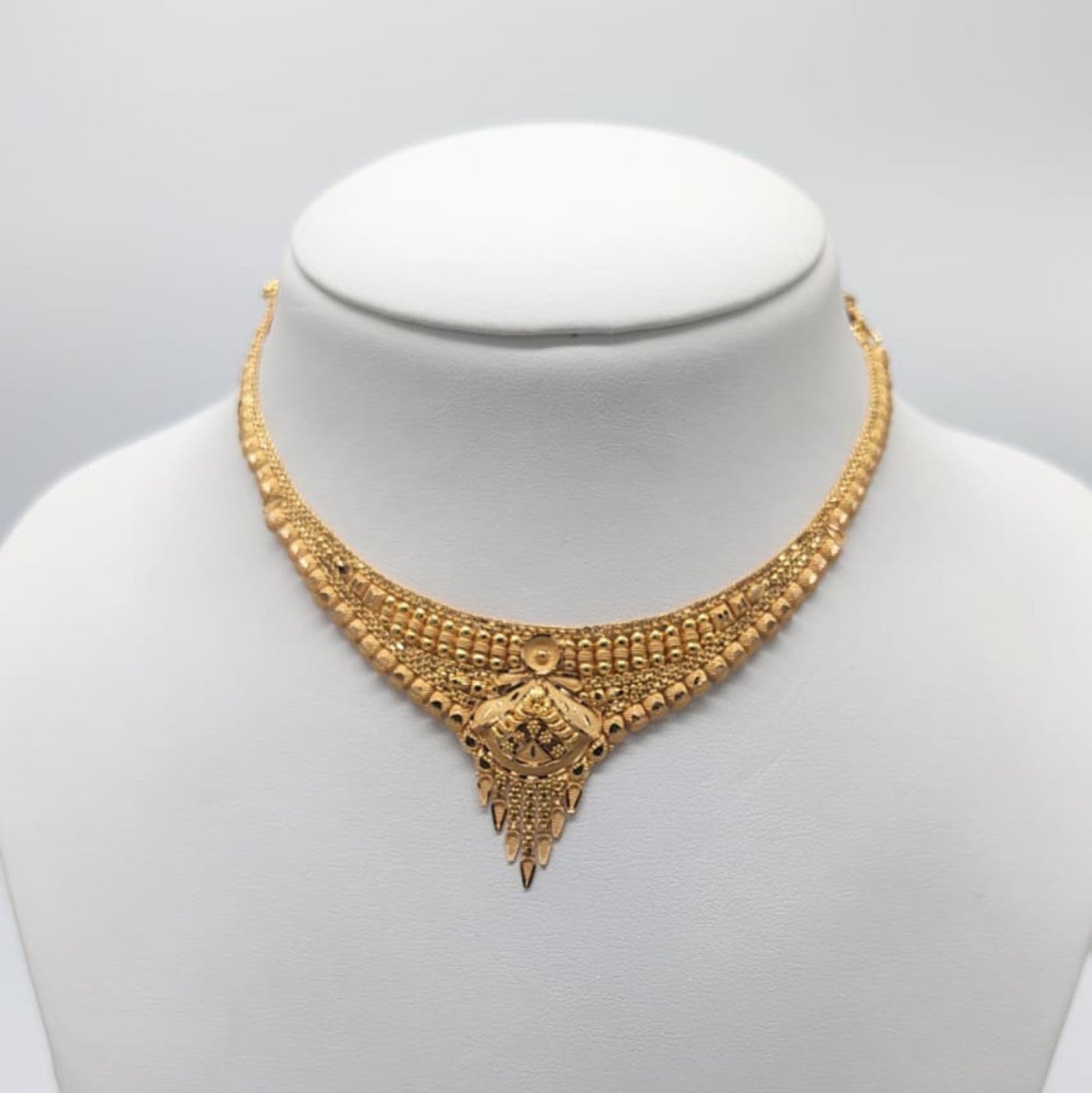 Gold necklace on a mannequin 