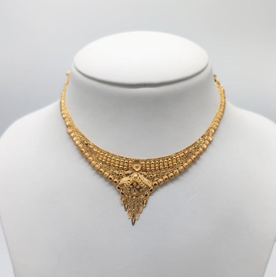 Gold necklace on a mannequin 