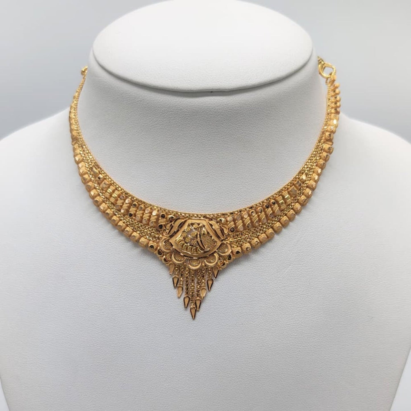 Gold necklace on a mannequin 
