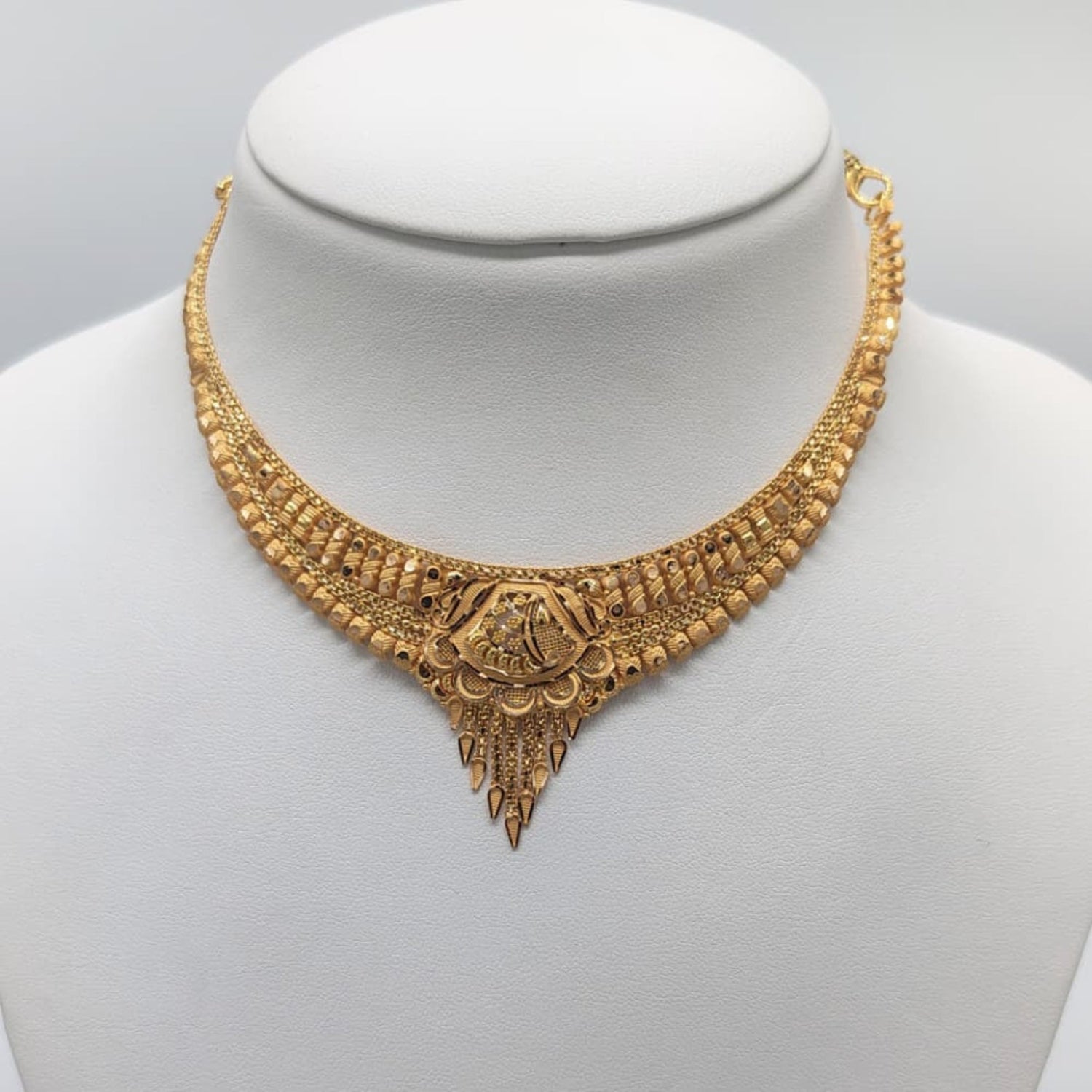 Gold necklace on a mannequin 