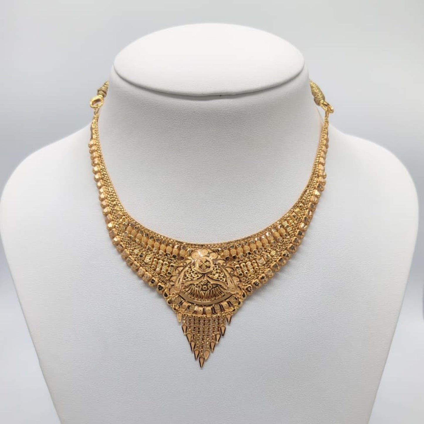 Gold necklace on a mannequin 