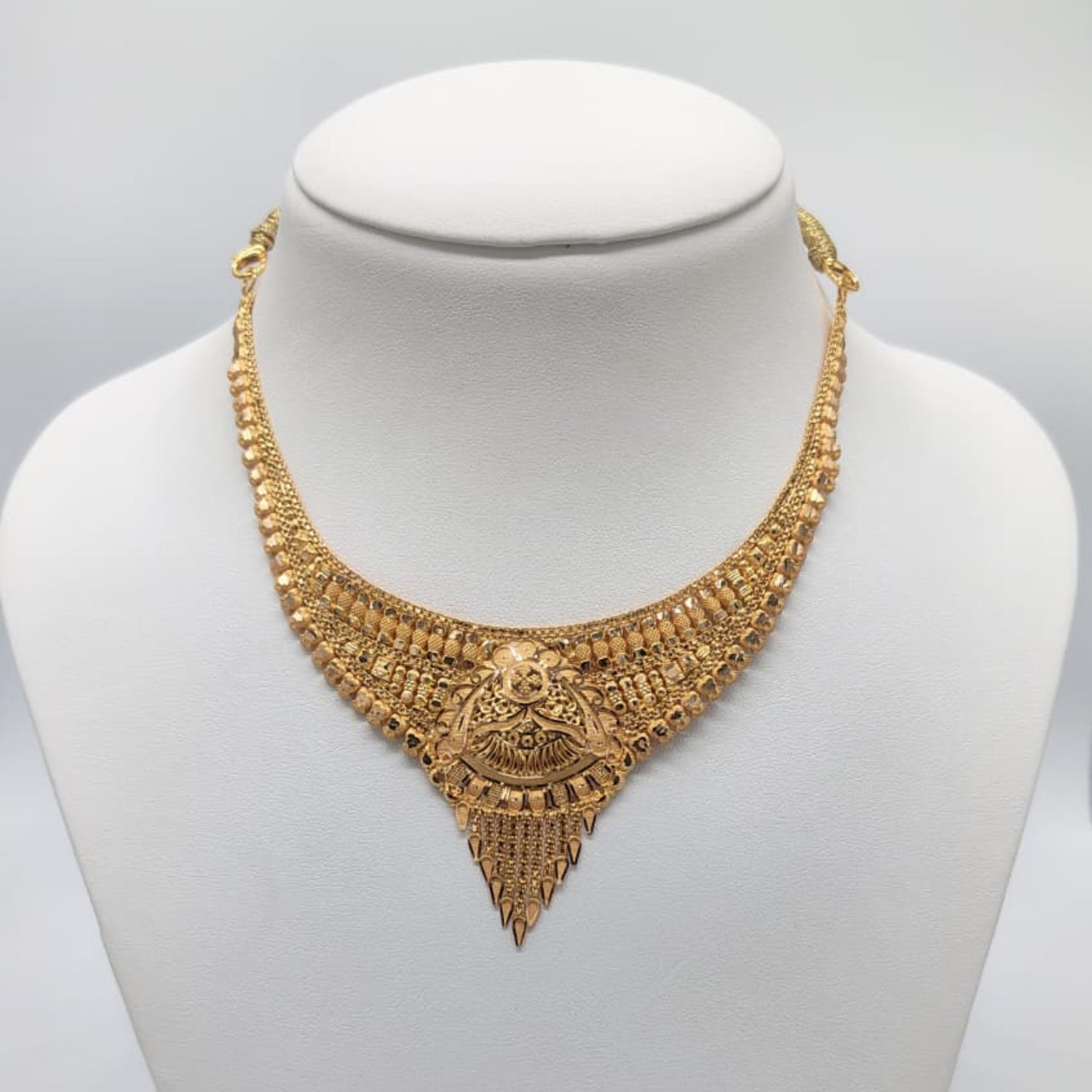 Gold necklace on a mannequin 