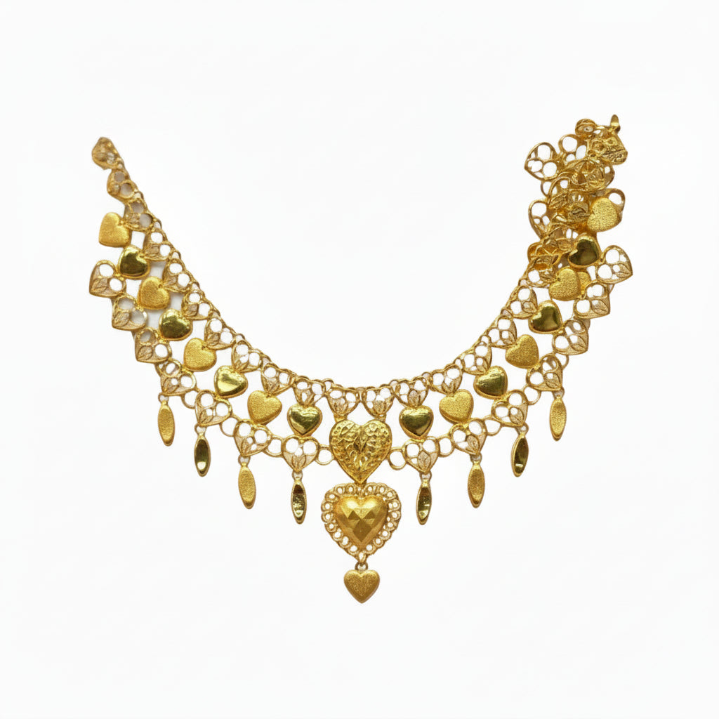 Gold necklace on a white card with a dark background