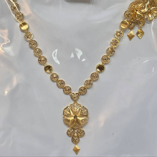 Gold necklace with intricate design on a white background