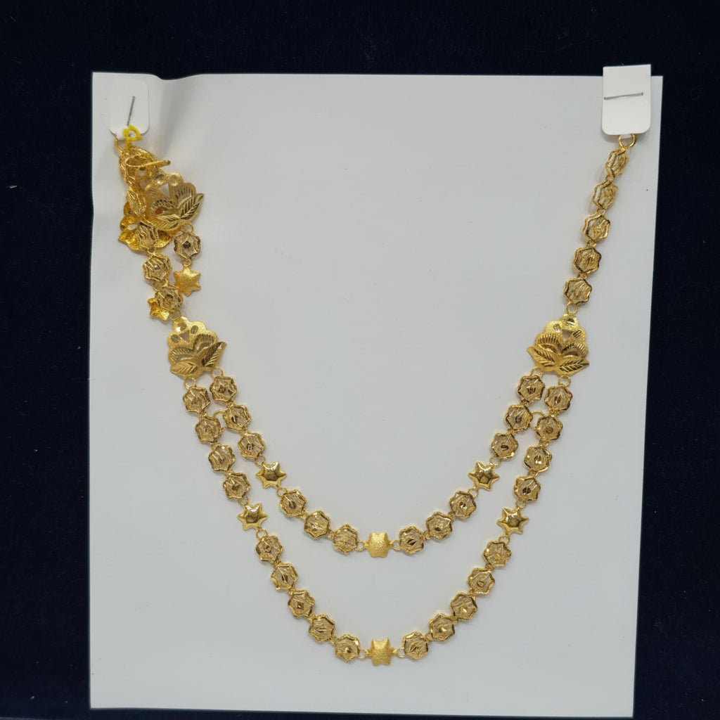 Gold necklace on a white card with a label