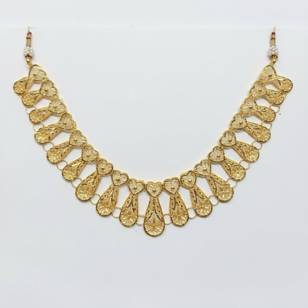 Gold necklace on a clear plastic bag with a price tag.